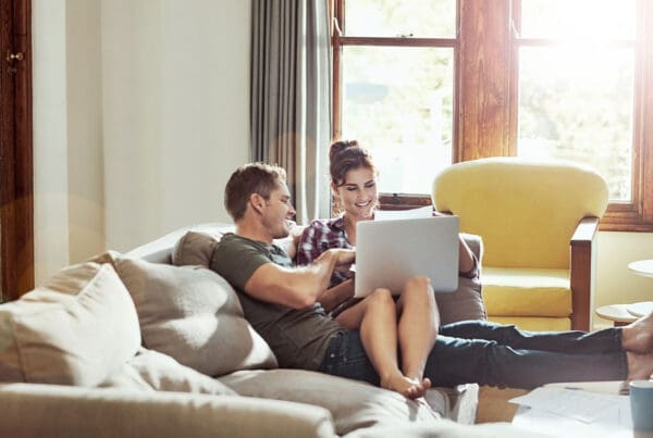Personal Insurance - Couple Looking at Laptop Together on Couch